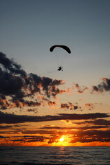 paraglider silhouette at sunset