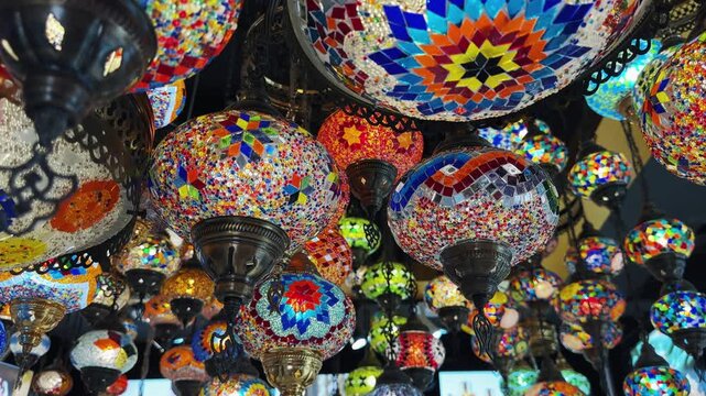 Traditional mosaic lanterns displaying vibrant colors in a decorative array in old market in Dubai