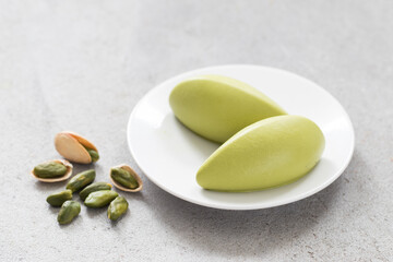 Pistachio cream dessert, quenelles. On a plate. Close-up	