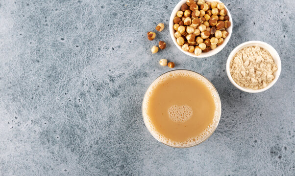 Traditional indian drink sattu in glasses with roasted gram flour, chickpeas on blue background. Indian food. Copy space