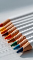 Obraz premium Organized Row of Colored Pencils, White and Rainbow Hues, for Art and Learning.