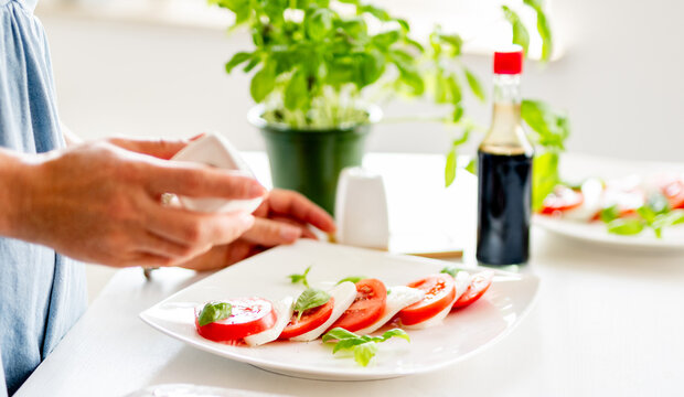 Woman Making Caprese Salad