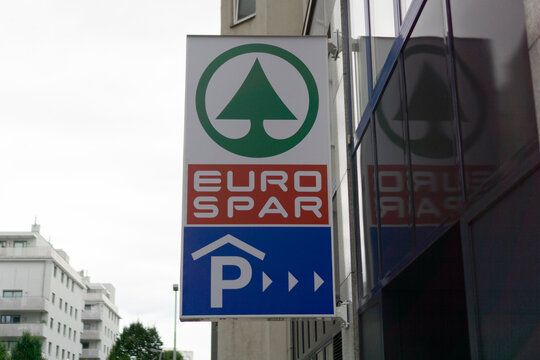 Vienna, Austria, Europe - August 24, 2025: a red, white, and green spar sign with the eurospar logo and a blue parking sign below, concept of retail, supermarket, and convenience store.