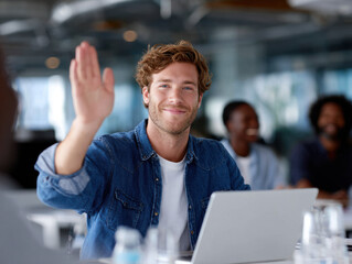 Smiling businessman raising hand during meeting in modern office
