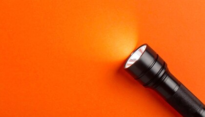 Black flashlight beam on orange background