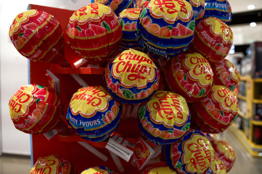 Rome, Italy - March 26, 2025: Colorful display of Chupa Chups lollipops in various flavors arranged on a retail shelf for enticing shopping experience