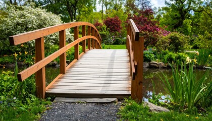 Obraz premium Wooden bridge over tranquil pond in a lush garden
