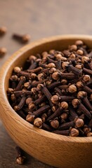 Aromatic cloves served in a rustic wooden bowl, perfect for cooking, baking, and traditional spice blends.
