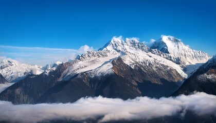Fototapeta premium snow capped mountains with clouds at the bottom