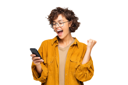 Excited Woman in Yellow Looks at Phone. Authentic shot ideal for social media, advertising.