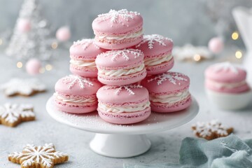 Pink christmas macarons decorated with snowflakes forming a pyramid on a white cake stand