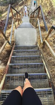 Desccending hike on metallic stairs at Diamong Head trail with a panoramic view of beautiful landscapes of Hawaii