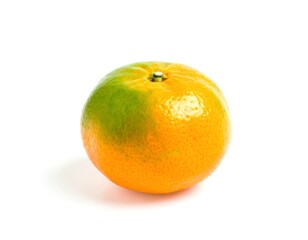 Ripe tangerine showing green patch isolated on white background