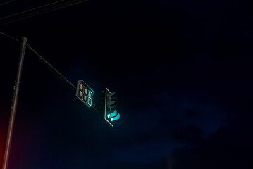 Traffic Signal Displaying Green Light at Night