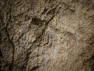 Brown stone on cave wall surface with cracked texture for abstract background and texture. Template for design, natural patterns, space for work, banner,seamless wallpaper, close up.