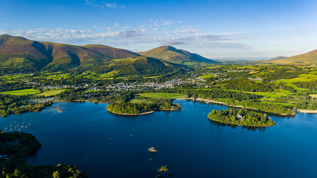 Golden evening light over the town of Keswick and Derwent Water in summer