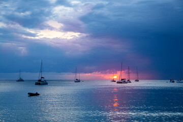 Sunset at sea. Amazing clouds and waves in sunset sky blue light cloud background. Sailing boats at sunset. Travel concept. Vacation travel holiday destination. 