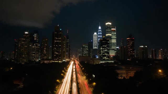 Aerial timelapse of Kuala Lumpur city skyline and traffic at night, Malaysia.