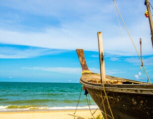 Wooden fishing boat on a sandy beach. Sunny coastal view