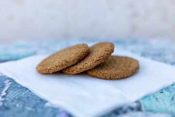 Cookies arranged on a napkin against a textured background during a sunny afternoon