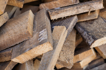Wood stacked neatly in a lumber yard for construction and artisan projects in a rustic environment during daylight
