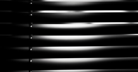 Minimalist monochrome abstract background of window blinds, light, and shadow