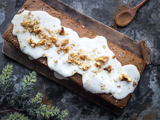 cinnamon cake with walnuts on a wooden board with a rustic background