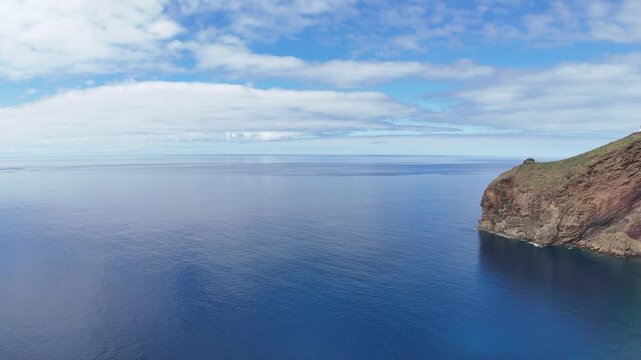Beautiful view of the mountains and the Christ the Redeemer Statue while flying over the city of Canico - in the south of Madeira Island, Portugal.