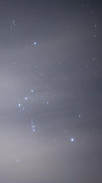 Orion Moving Through Thin Clouds - Winter Night Sky Time-lapse (Vertical, PANNING)