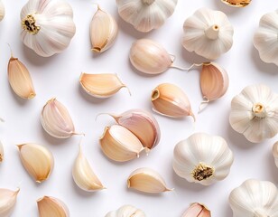 Fresh Garlic Cloves and Bulbs Scattered on a White Surface, Close-Up View