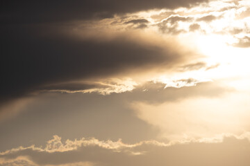 Dramatic clouds create a captivating sky display during sunset at a serene landscape