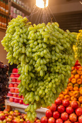 Juicy Green Grapes Close-Up with Soft Market Background.