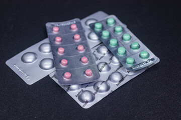 Loaded blister strip for pills on black background.