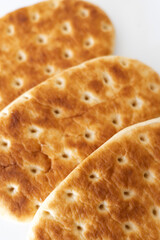 Freshly baked flatbreads displayed on a clean surface, highlighting their golden-brown crust and unique texture, perfect for any meal or gathering