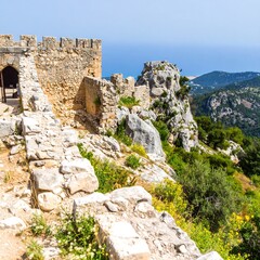 Ancient stone walls and rocky hillside landscape