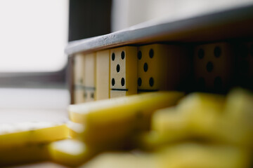 Colorful dominoes arranged neatly on a wooden surface, capturing a moment of tranquility and focus...
