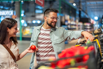 Happy Couple Shopping For Fresh Produce in a Vibrant Grocery Store