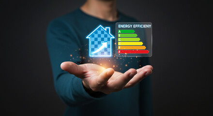 Hand holding energy efficiency rating chart with house icon, sustainable energy and eco friendly concept