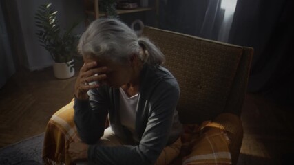 Senior woman contemplates life journey with melancholy at home - Powered by Adobe