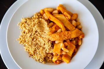 A classic Brazilian dish known as dobradinha, prepared with beef tripe, white beans, and tropical...