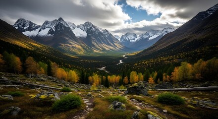 Obraz premium Majestic Autumn Mountain Valley Landscape with Winding River and Vibrant Fall Foliage Under a Dynamic Sky
