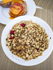 Healthy breakfast with oatmeal, cranberry and hemp seeds with toast and cheese