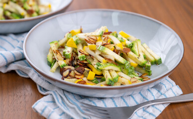 Close up of Simple Vegetarian Side with Green and Yellow Zucchini and Toasted Almonds