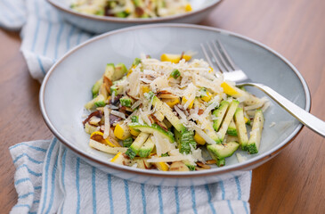 Close up of Simple Vegetarian Side with Green and Yellow Zucchini and Toasted Almonds