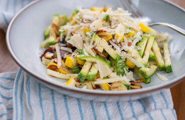 Close up of Simple Vegetarian Side with Green and Yellow Zucchini and Toasted Almonds