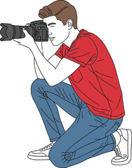 Young man with a camera taking a photograph in a kneeling position outside now