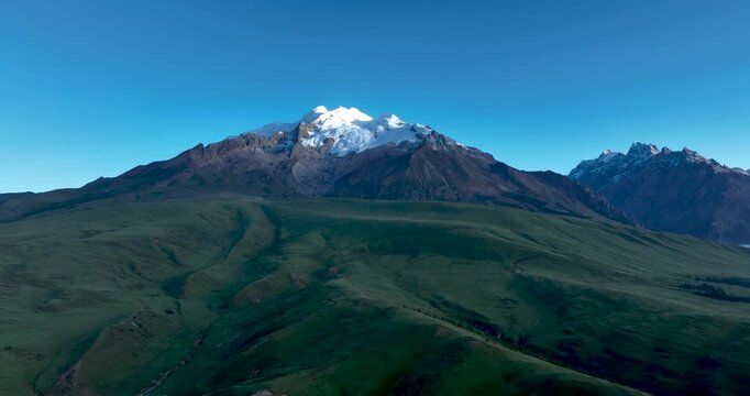 Beautiful green grassland and snow capped mountain in Litang county, China
