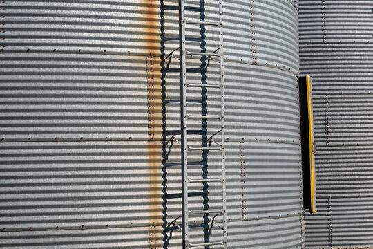 Close-Up of Metal Ladder on Weathered Corrugated Metal Grain Bin &ndash; Agriculture and Harvest Concept &ndash; Rural Farm Architecture - Horizontal