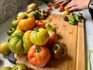Flat lay of heirloom vegetables including hot peppers, tomatoes, and colored corn
