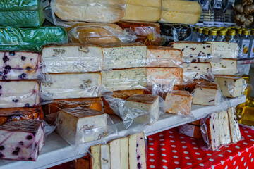 Medium View of Cheese Stall with Variety of Cheeses